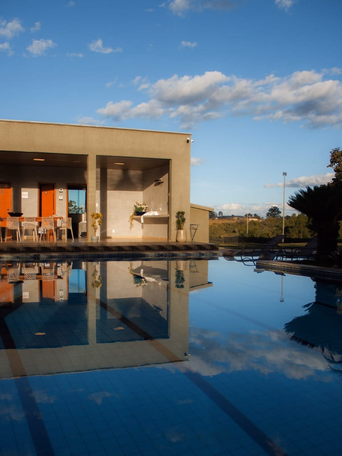 Piscina de raia com reflexo da casa, dia